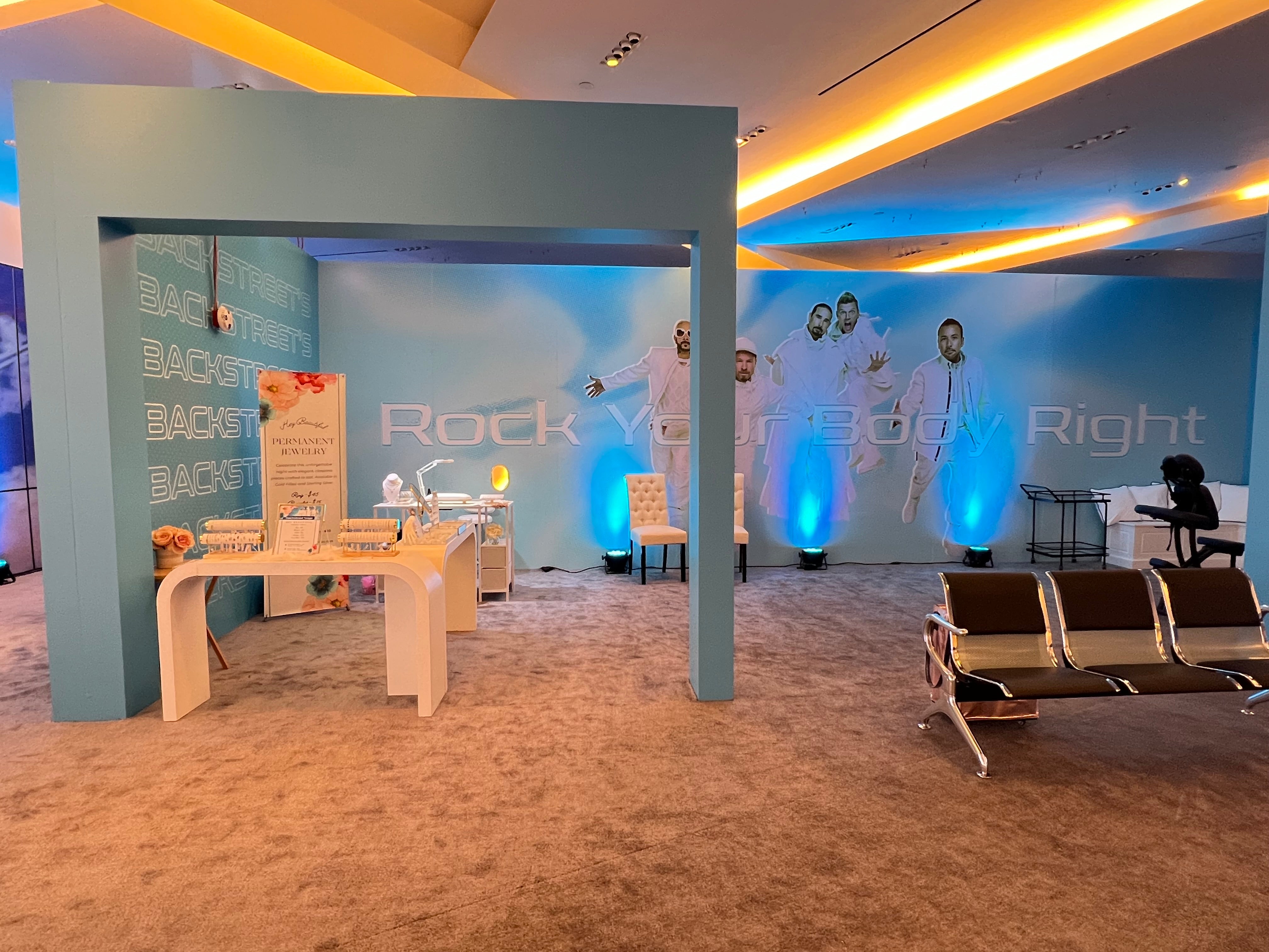 Backstreet Boys Fan Experience signage near the permanent jewelry activation