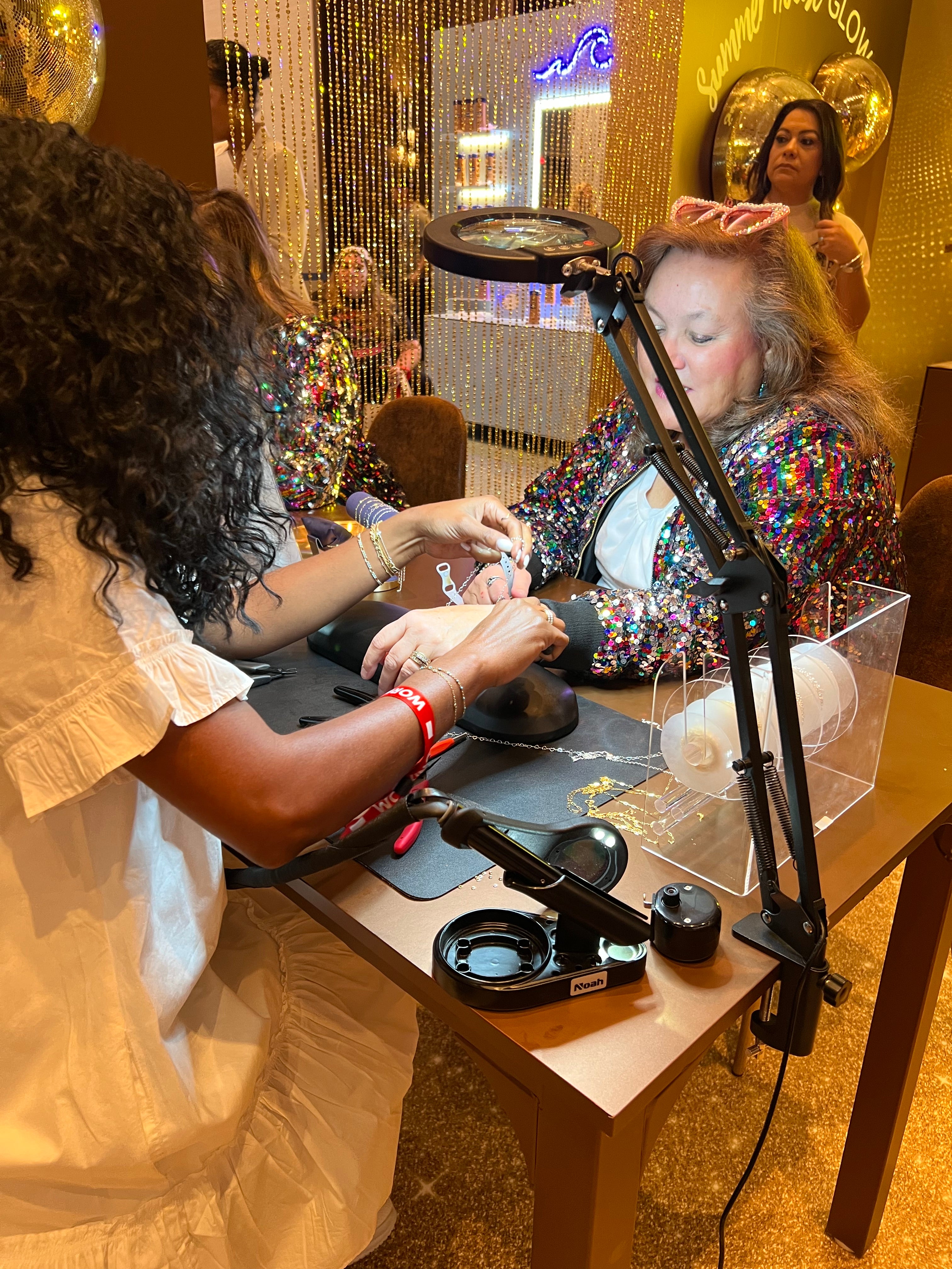 Permanent jewelry team providing on-site welding services for Vaseline at BravoCon