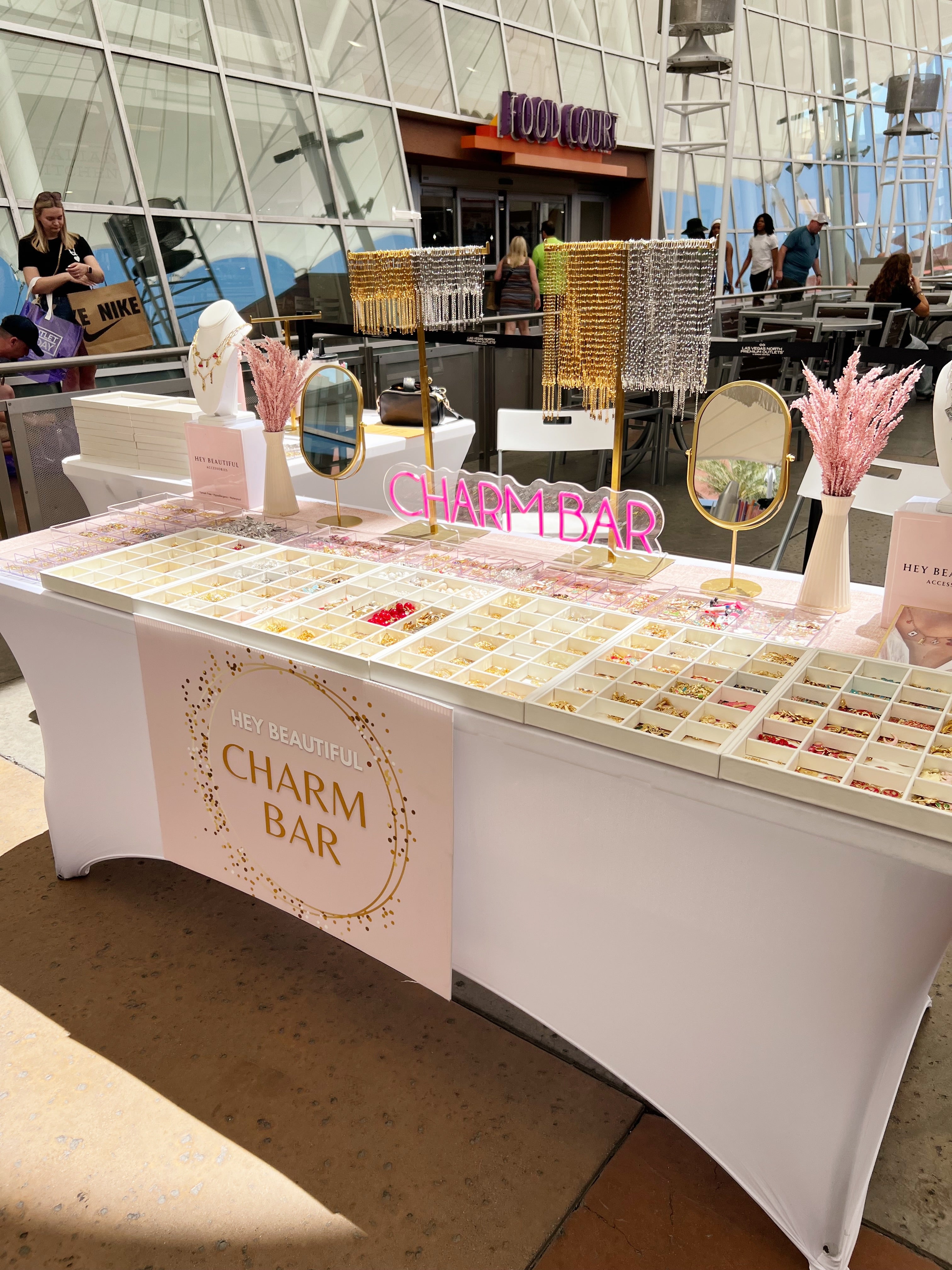 Charm bar setup with various charms on a table in a public area in. las vegas